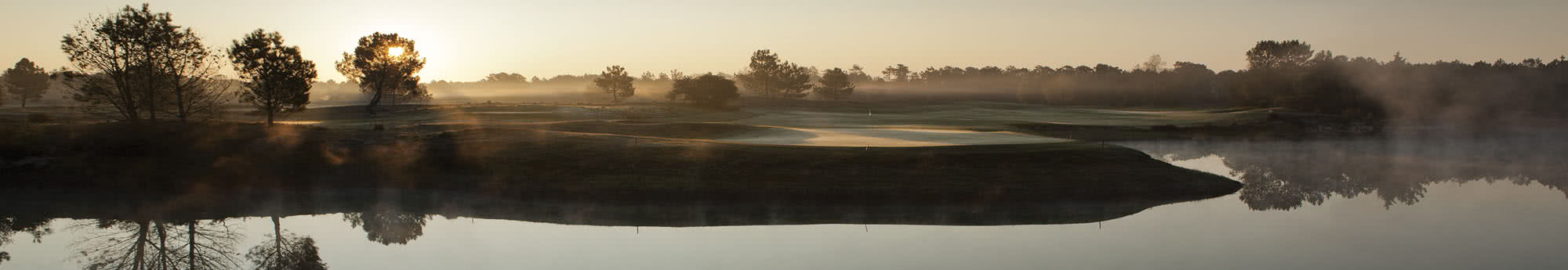 Golf course in the morning with mist and a Sunrise